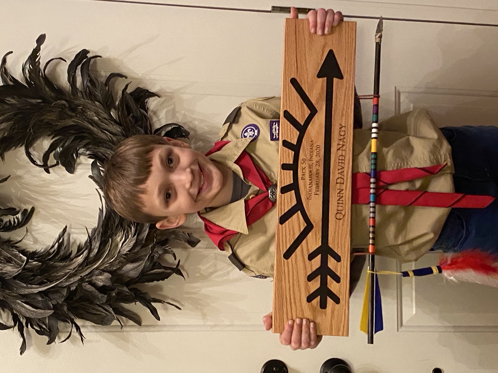 Quinn holding his engraved Arrow of Light plaque with his name, Quinn David Nagy.